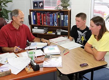 A teacher, parent, student conference in progress